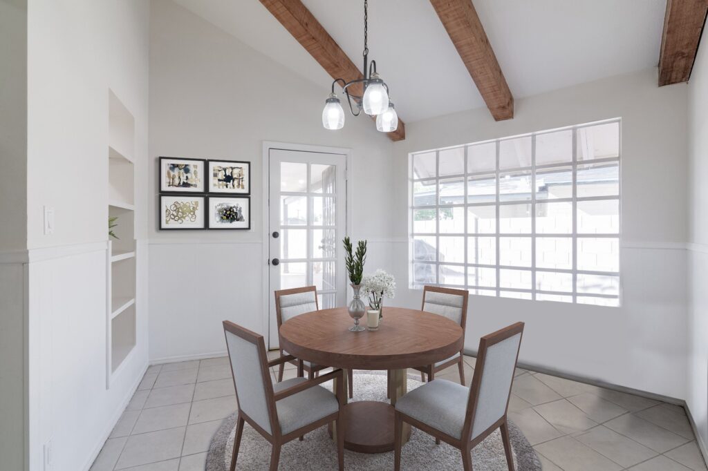 Adorable breakfast room with bright windows, door to patio, and natural wood beams.