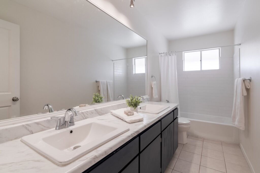 Hall bath with bright natural light, new countertops and double sinks. Combo shower/tub.